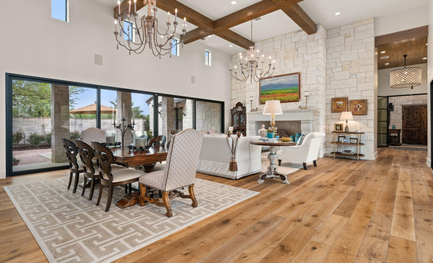 Custom stone fireplace, 18 foot beamed ceiling, 24 ft. sliding glass doors adding an abundance of natural light, #2 and #3 courtyards, formal living, dining