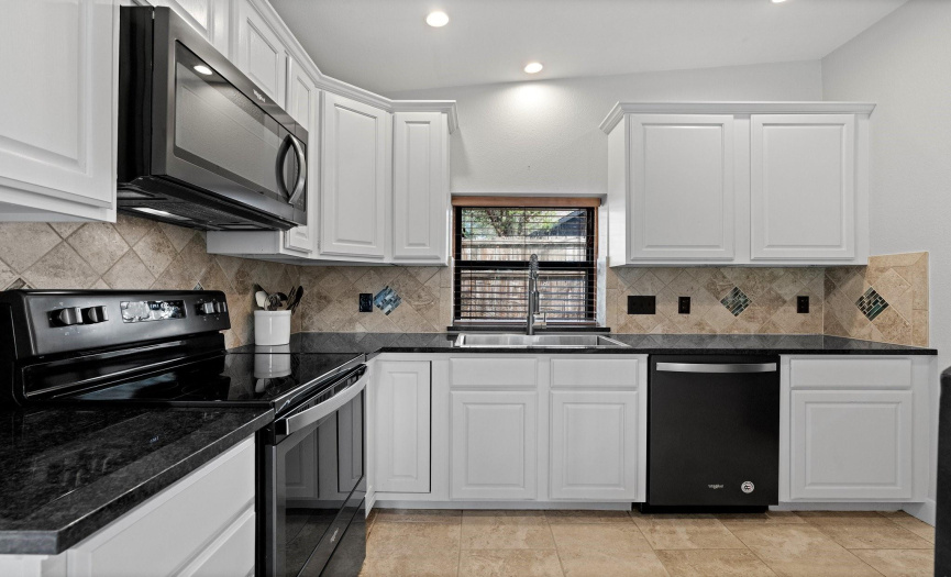 Updated Kitchen with black granite counters.