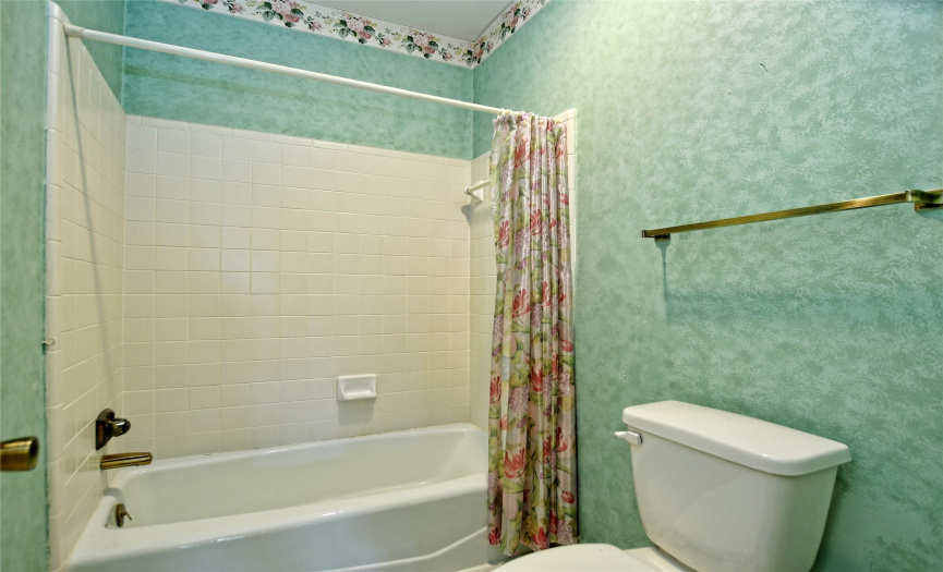 A separate walk-in shower, not seen in this photo, is also included in this primary bathroom.