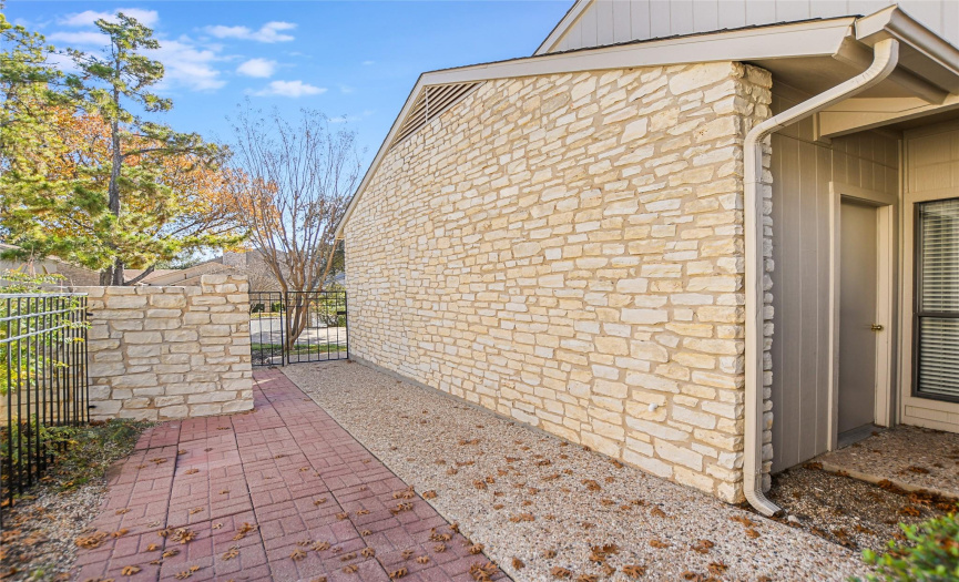 A private, gated courtyard provides a quaint and welcoming entrance.