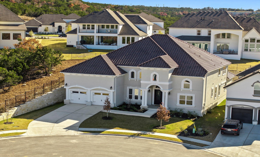 Crowning the residence is a stunning tile roof that not only adds to the architectural elegance but also speaks to the durability and longevity of the home.