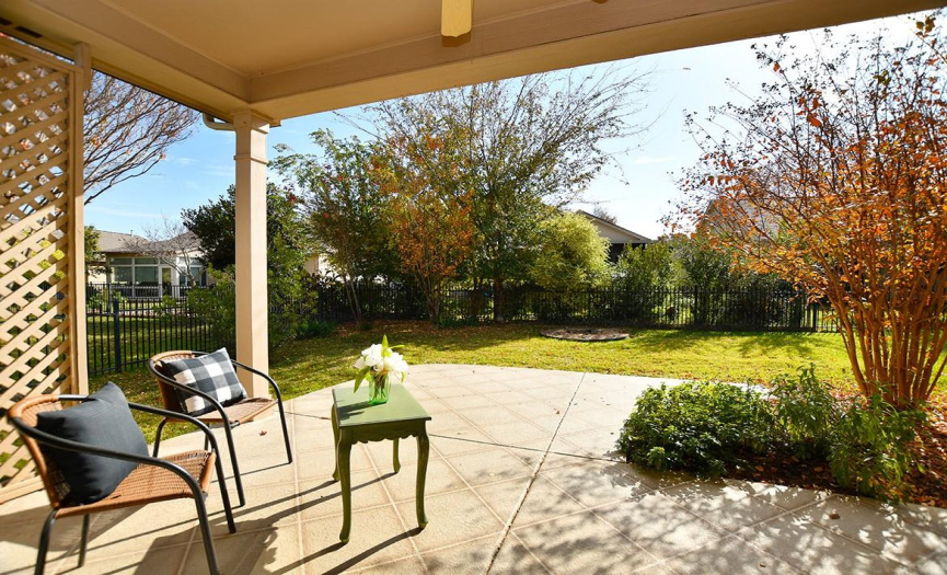 A charming southeast-facing patio under the original roofline looks out into the fenced back yard.