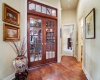Rich wooden French doors with a transom window welcome you into your home library/office