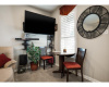An additional space suitable for a quaint dining area sits beside the living room.