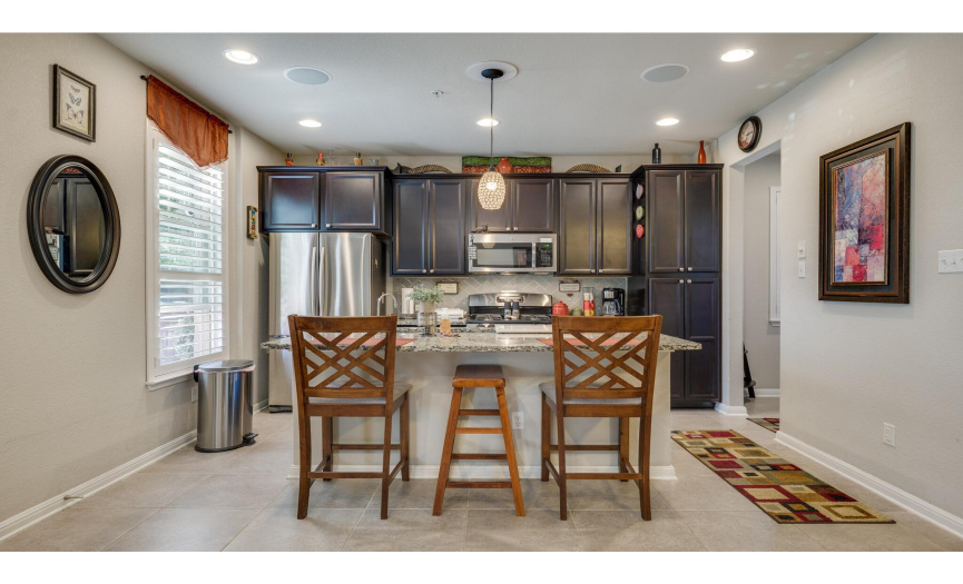 The kitchen boasts elegant espresso cabinetry and a breakfast bar.