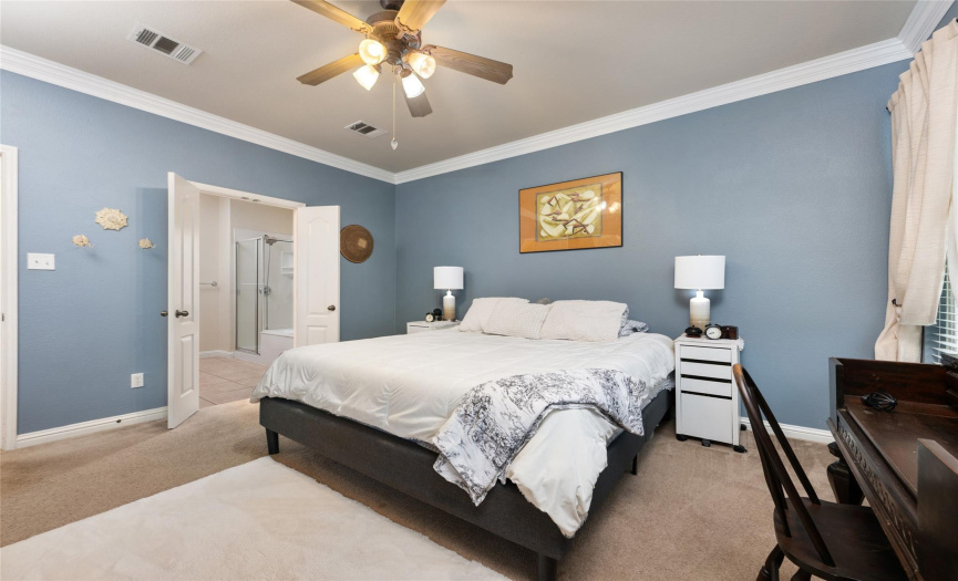 This Primary Owner's suite also features new windows, crown moldings, a ceiling fan and has a beautiful ensuite bath.