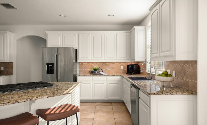 The deluxe gourmet kitchen comes fully equipped with built-in SS appliances, sleek granite countertops, and elegant tile backsplash.