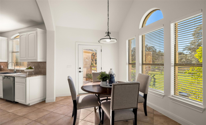 The sunny breakfast area offers space for a sizable kitchen table and overlooks the expansive acreage making it a serene space for enjoying meals with friends and family. 