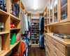 The large walk-in closet comes complete with a gorgeous custom organizational system. 