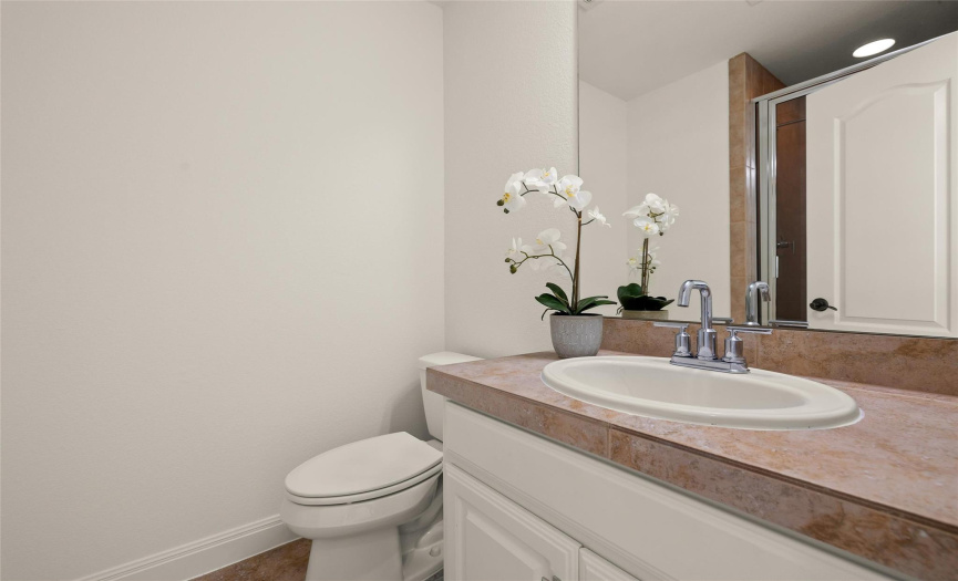 The second floor full bath provides a single vanity and a walk-in shower with tile surround.