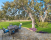 Enjoy outdoor entertaining and relaxing with the large stone patio, which overlooks your private, sprawling, tree-filled acreage that stretches beyond the fence line. 