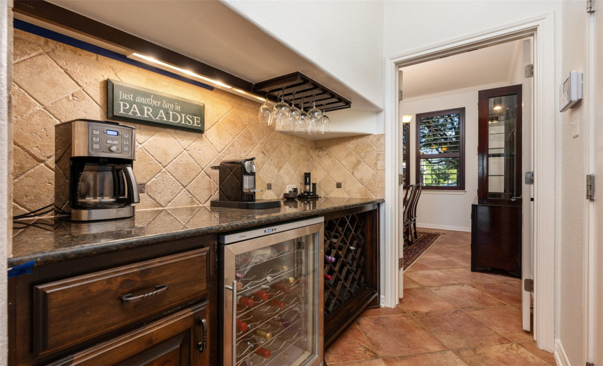 Extended butlers pantry/coffee bar and wine bar with additional fridge, cabinetry and counter space flows between the kitchen and formal dining room.