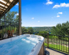 Lower deck provides an opportunity to soak in this relaxing hot tub with family and friends while taking in the lake and hill country views.