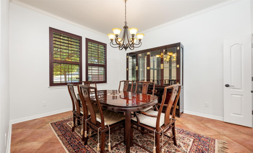 Large dining room with plantation shutters.