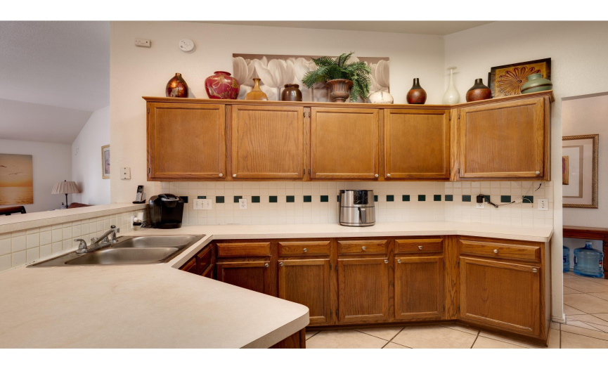 The kitchen offers plentiful counter space and excellent cabinetry storage plus a pantry. 