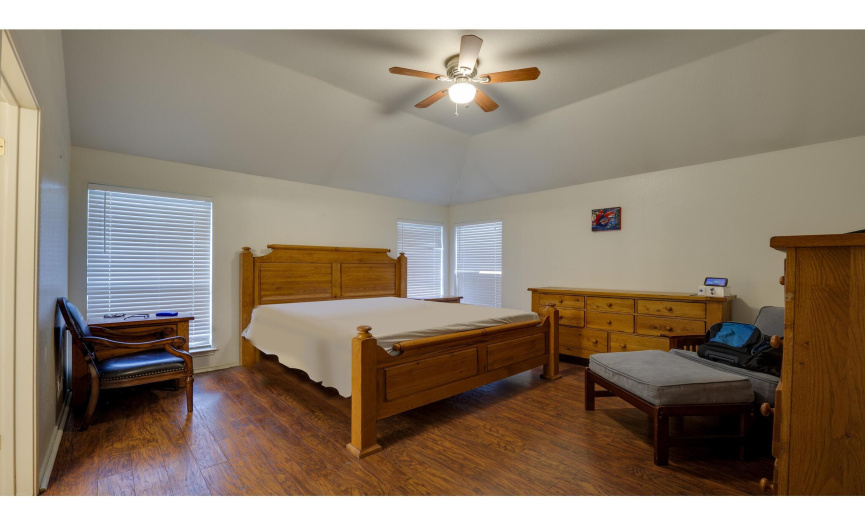 The sizable primary suite comes complete with a private ensuite bath and walk-in closet. 
