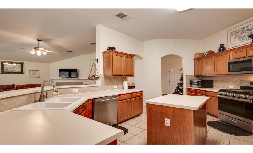 The home chef will love this spacious open-concept kitchen with a convenient center island and plentiful counter space and cabinetry storage. 