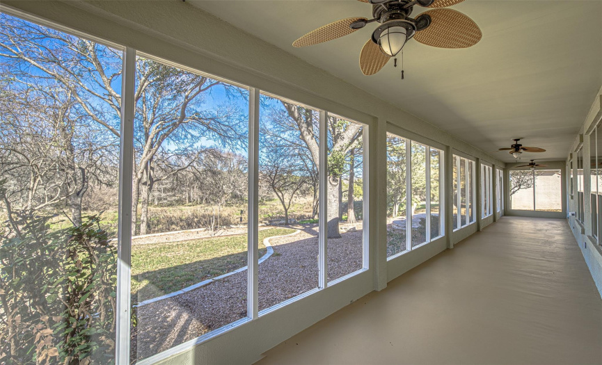 Opposite view of the screened porch with ceiling fans