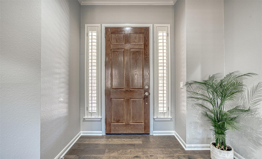Foyer entrance with side panels and plantation shutters for privacy.