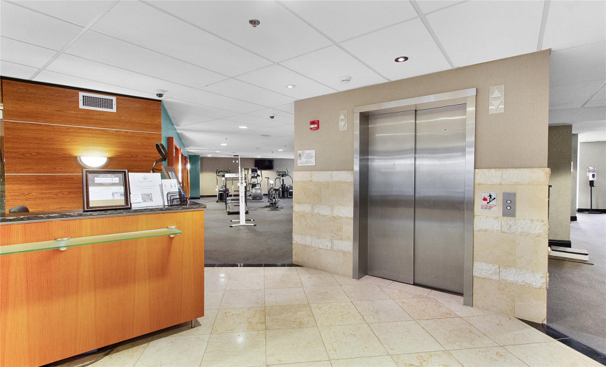 Spa Registration Desk, Elevator (Multiple elevators located throughout the community), & Fitness Center Entrance