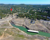 This aerial image shows the cove which extends toward the lot marked with a red flag.