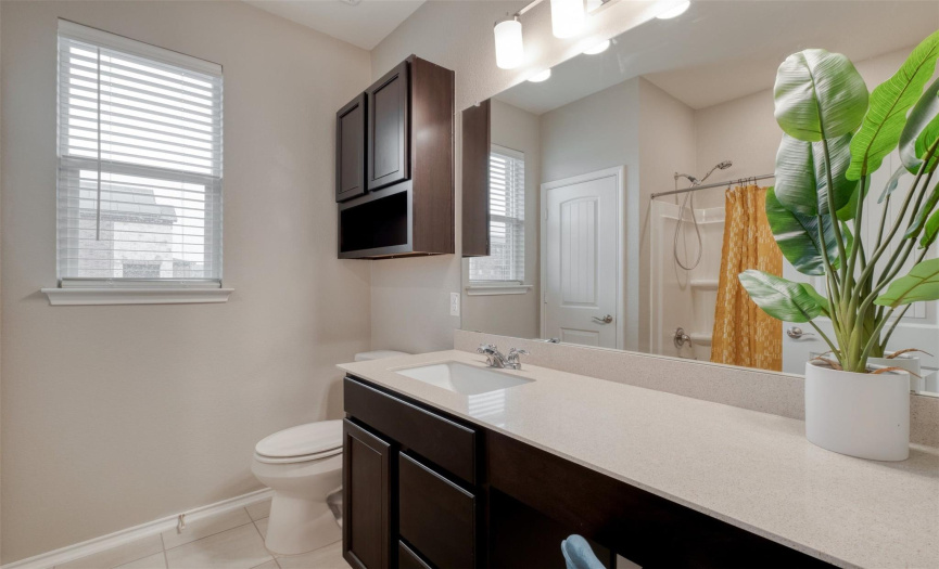 The second full bath is well-appointed for both bedrooms and offers ample vanity space with a make up counter.