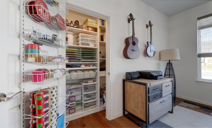 Custom shelving in the flex room closet perfectly organizes office & craft supplies. 