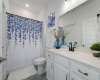 The attached, private guest bath features a tiled tub/shower combo and large walk-in closet.