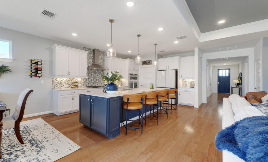 Beautiful hardwood floors grace the entryway and open concept great room/kitchen/cafe.