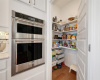 Walk-in corner pantry with custom sliding drawer storage for all your needs.