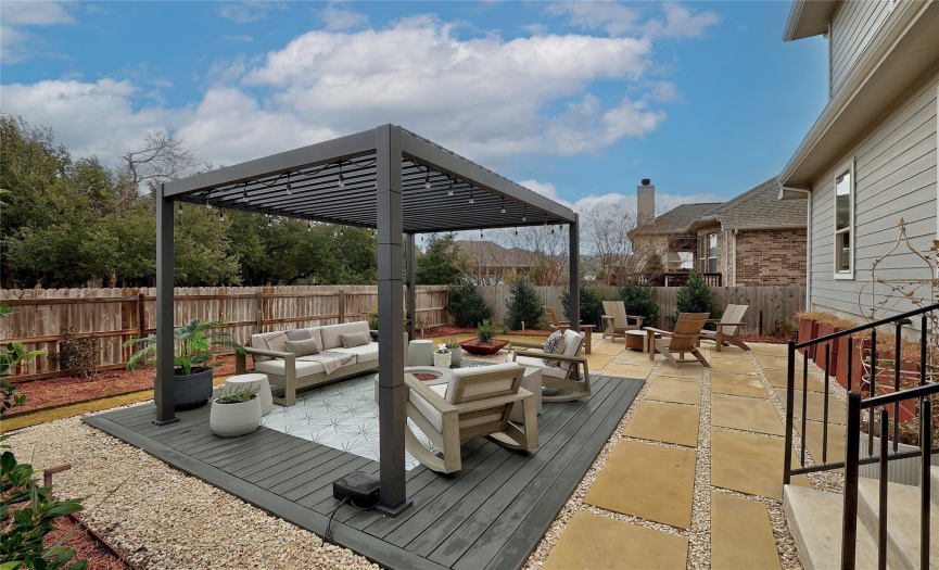 A large, beautiful pergola with adjustable sun slats to let in more or less sunshine. The space is truly a vibrant oasis!