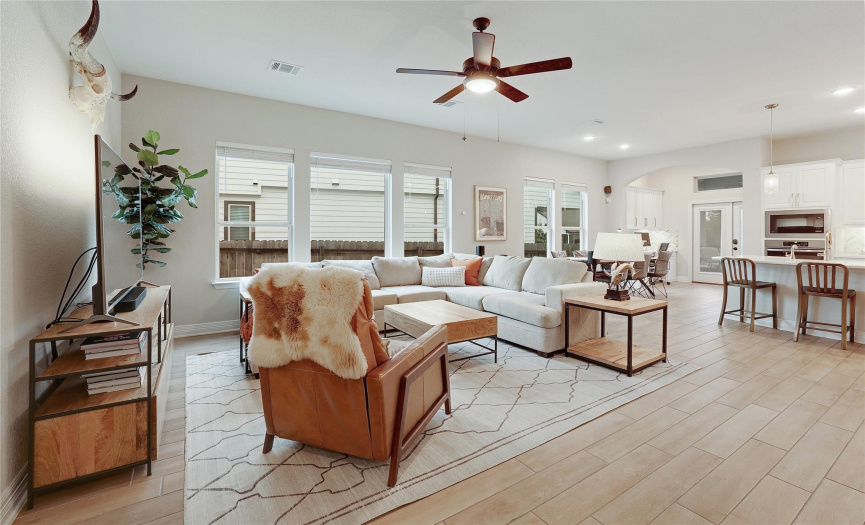 You'll appreciate the tile flooring with wood-like appeal in the downstairs living areas. Throughout the home, there are arched doorways, beautiful accents and an abundance of natural light and recessed lighting. 