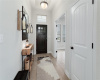 The large foyer is adorned with a pendant light and has a convenient coat closet and accent window above the door.