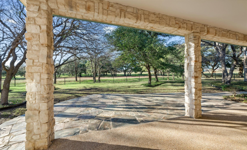 Back covered patio with stone extension overlooking the greenbelt an the 18th and 10th hole