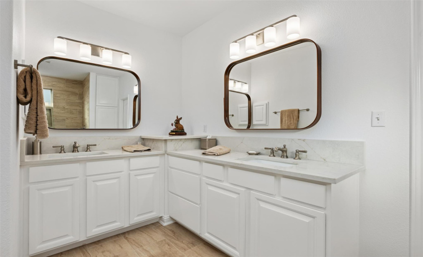 Primary bath with dual vanities, quartz counters, new mirrors and lights, and fixtures