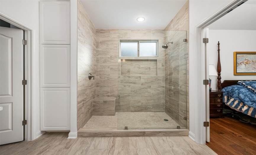Huge primary shower completely updated with new tile, shower seat, and fixtures.