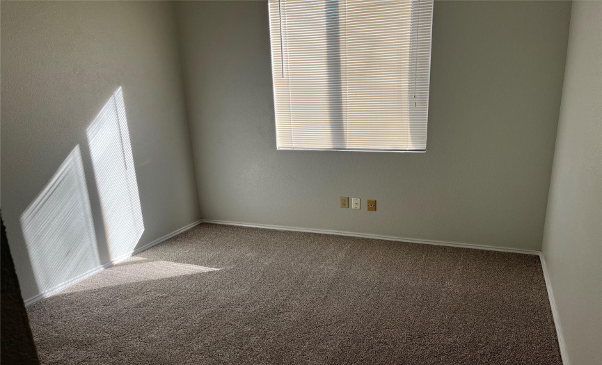 The second standard bedroom with clean carpet & blinds.
