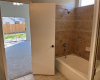 View of the combo shower & tub in the master bedroom bathroom.