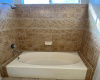 Another view of the garden tub & shower in the master bedroom with nice tile surroundings & a window above.