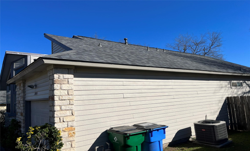 View of the front side of the house & view of the new roof installed in October 2023.