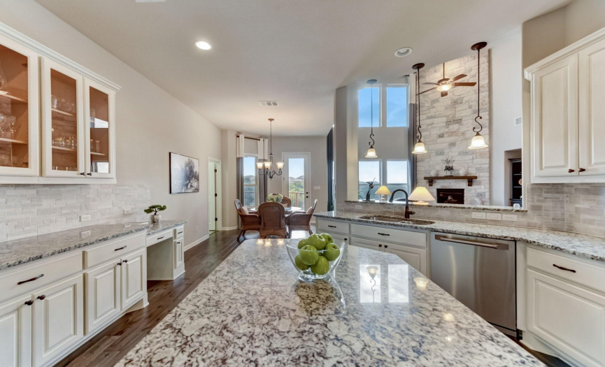 Granite countertops, a tasteful tile backsplash, and professional grade stainless steel appliances aid in creating everything from a quick snack to an elaborate meal made for a crowd