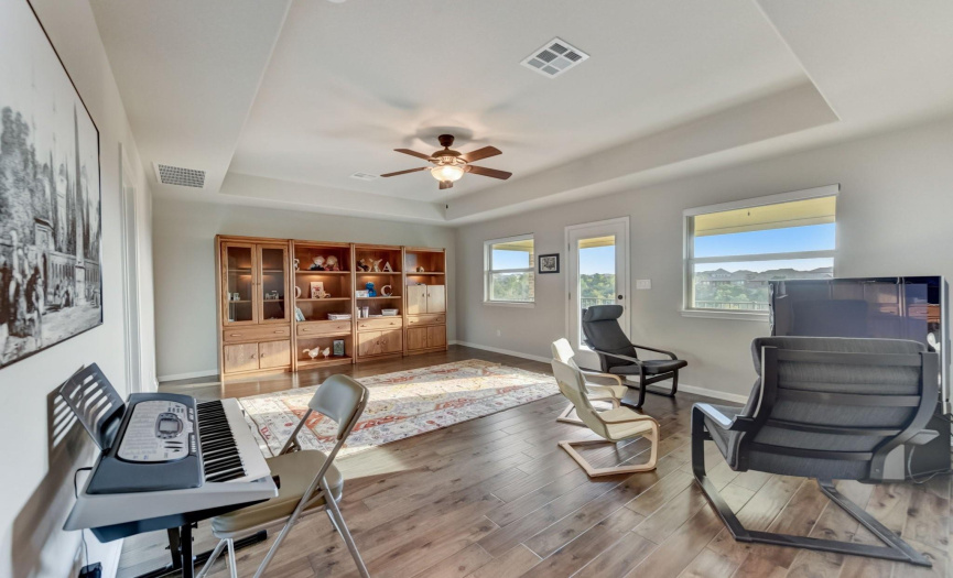 On the upper level, a versatile game room opens to a private balcony with incredible views