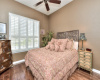 Guest bedroom with hardwoods, Plantation shutters and ceiling fan