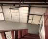 Unit 3A- View of Overhead door and side door from top of stairs.