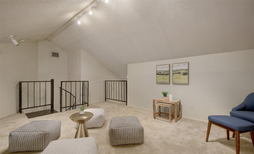 Another perspective of the third bedroom, highlighting its loft-style charm and the potential for various uses.