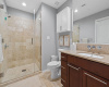 Lovely walk-in shower, large vanity with ample storage.