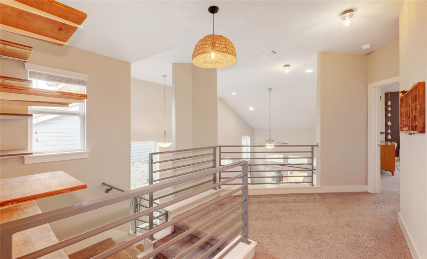 Enjoy the upstairs landing with built in shelves, modern stairway railings and upgraded light fixtures.