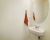 The half bath / powder room downstairs is convenient to the main living area for guests easy access.