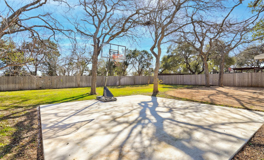 Huge backyard includes a sport court. Vacant treed lot behind.