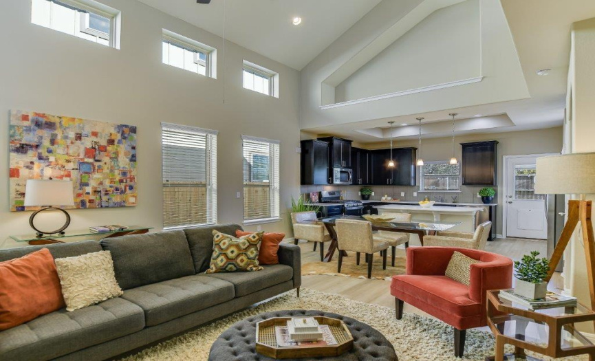 The soaring two-story ceiling and clerestory windows bring light and space into the home.  All of the lower windows include wood blinds for privacy when needed.